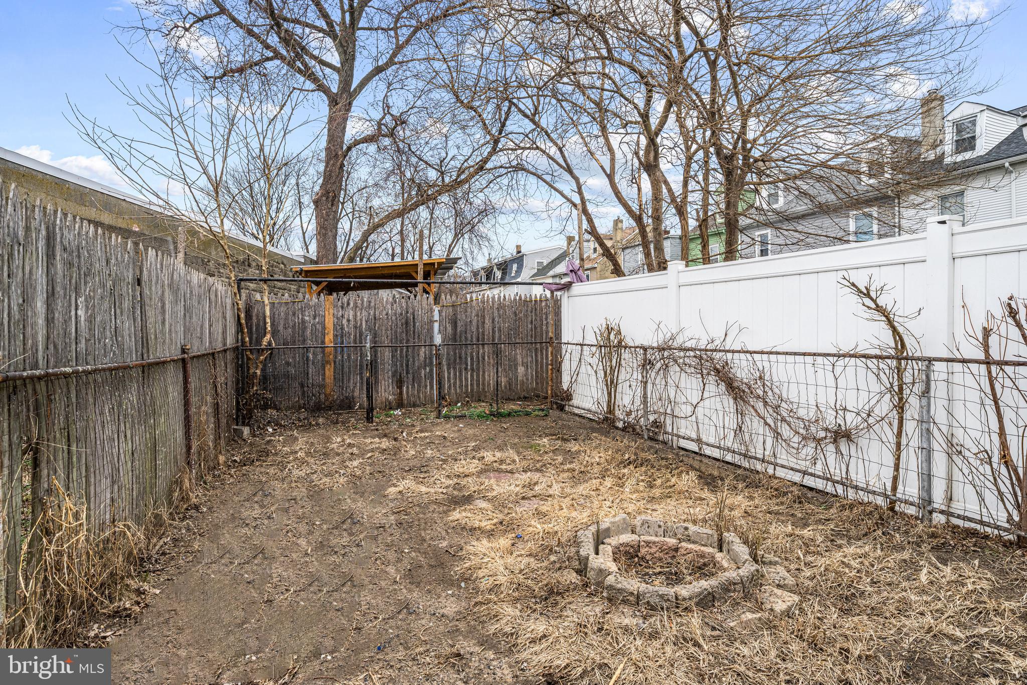 239 3rd Street Gloucester City, NJ 08030 - Photo 20 of 20 a view of backyard with wooden fence and large trees