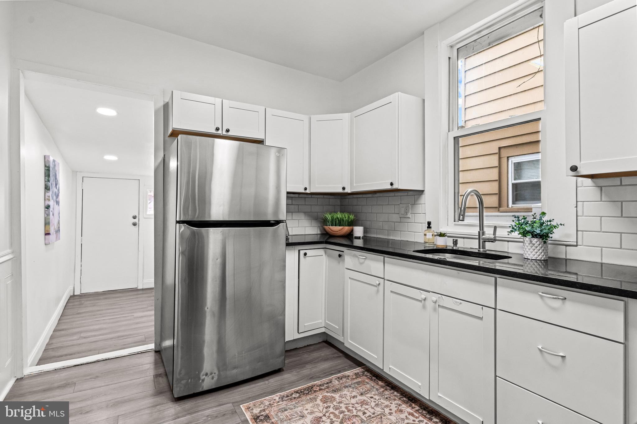 239 3rd Street Gloucester City, NJ 08030 - Photo 7 of 20 a kitchen with stainless steel appliances granite countertop a refrigerator and a sink
