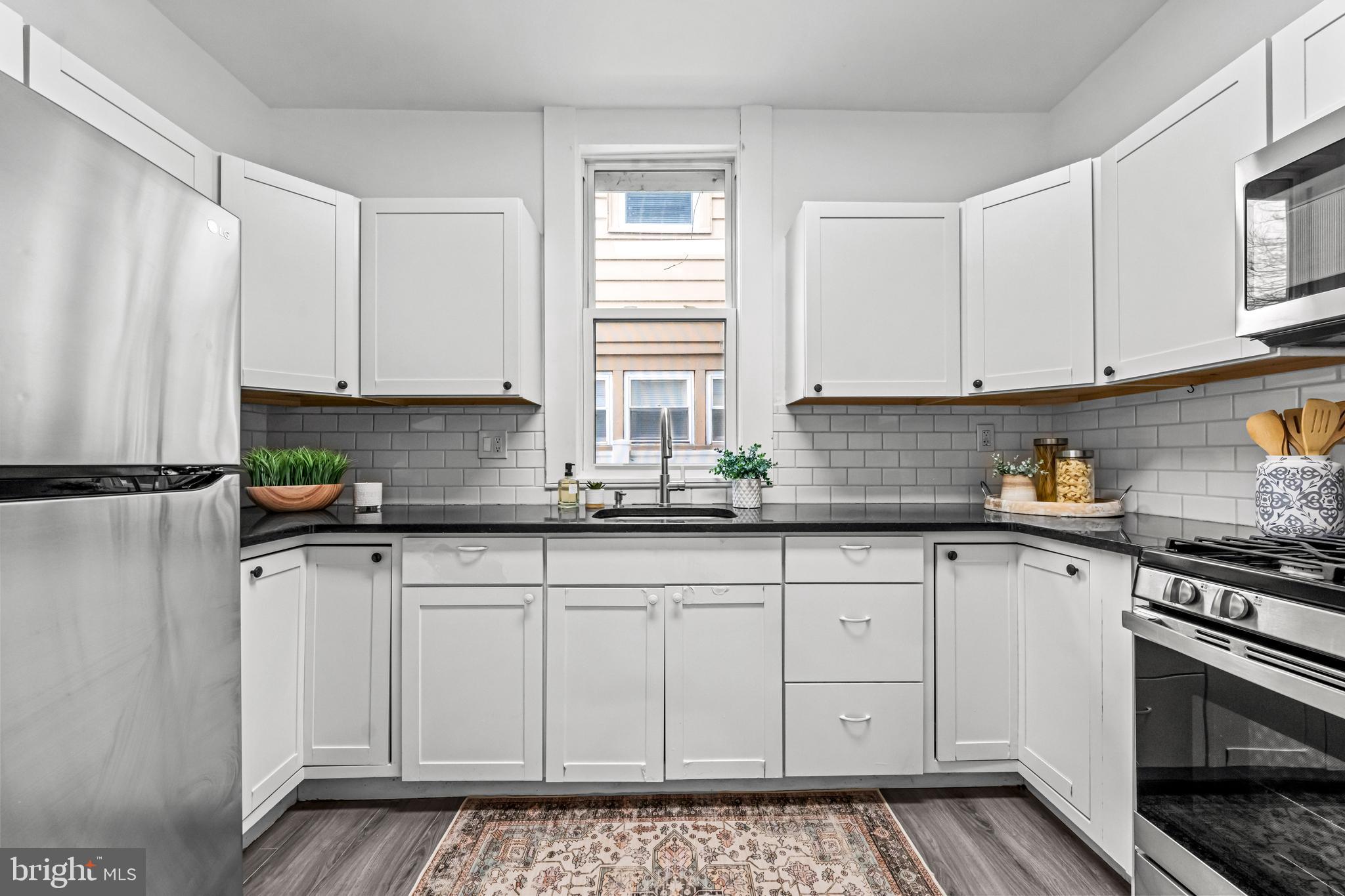 239 3rd Street Gloucester City, NJ 08030 - Photo 8 of 20 a kitchen with stainless steel appliances granite countertop a sink stove and cabinets