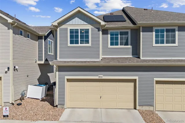 a front view of a house with a garage