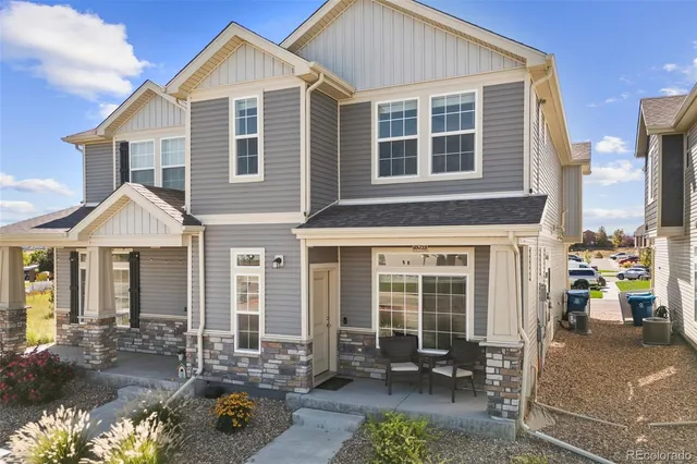 a front view of a house with outdoor seating