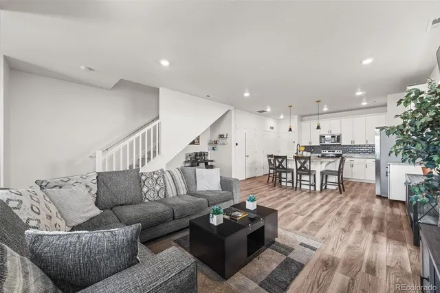 a living room with furniture and wooden floor