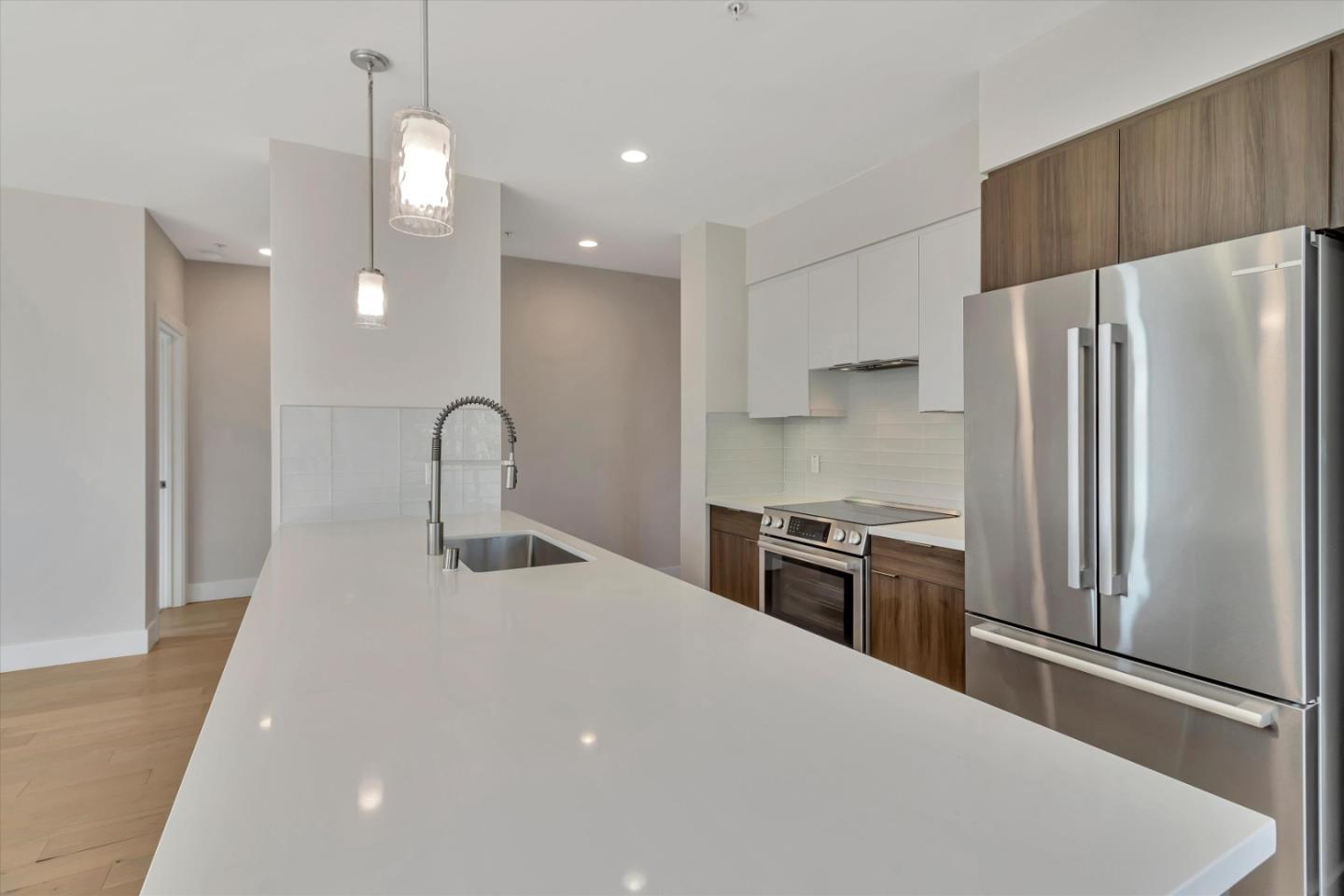901 Jefferson Street, Unit 510 Oakland, CA 94607 - Photo 8 of 15 a kitchen with stainless steel appliances a refrigerator sink and stove