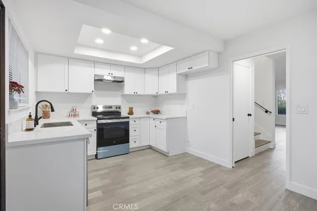 a kitchen with white cabinets and white appliances