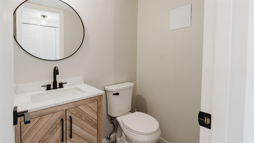 272 Preston Way, Unit 272 Boca Raton, FL 33434 - Photo 9 of 20 a bathroom with a sink a mirror and a toilet