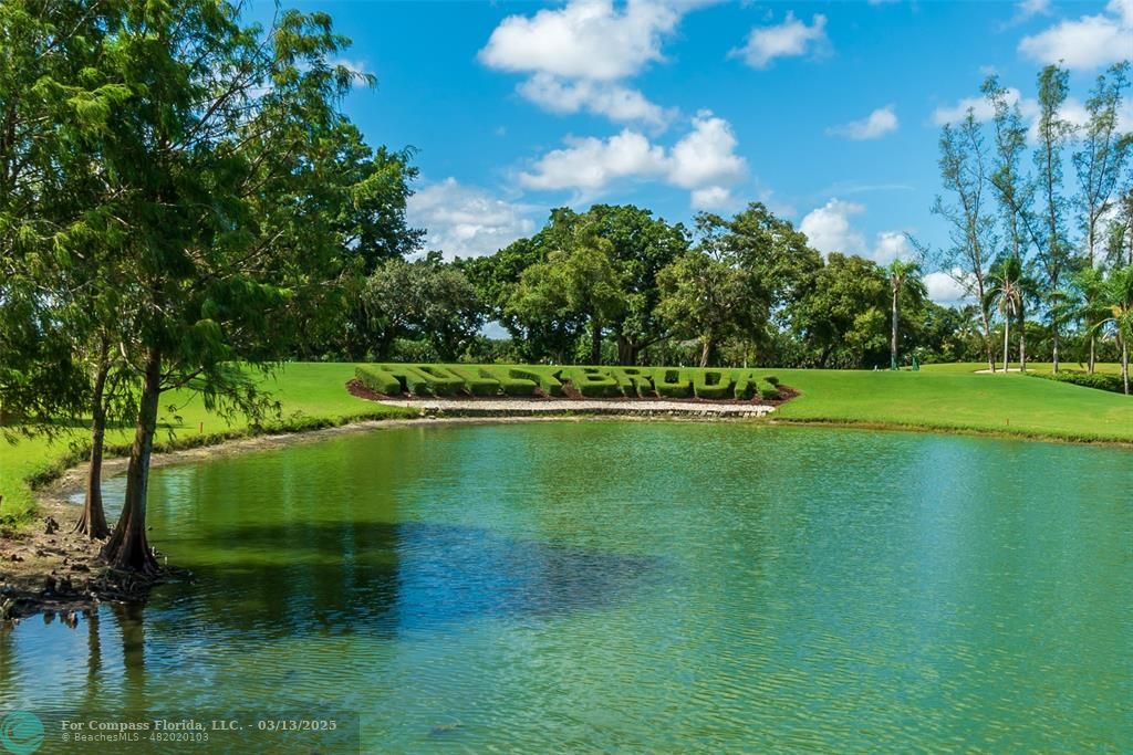 8990 South Hollybrook Boulevard, Unit 301 Pembroke Pines, FL 33025 - Photo 18 of 52 a view of a golf course with a lake