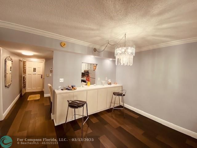 8990 South Hollybrook Boulevard, Unit 301 Pembroke Pines, FL 33025 - Photo 2 of 52 a view of a room with wooden floor and chandelier