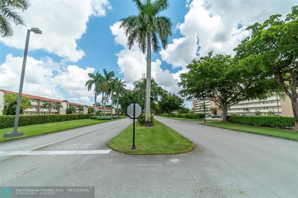 8990 South Hollybrook Boulevard, Unit 301 Pembroke Pines, FL 33025 - Photo 49 of 52 a view of a garden with a fountain
