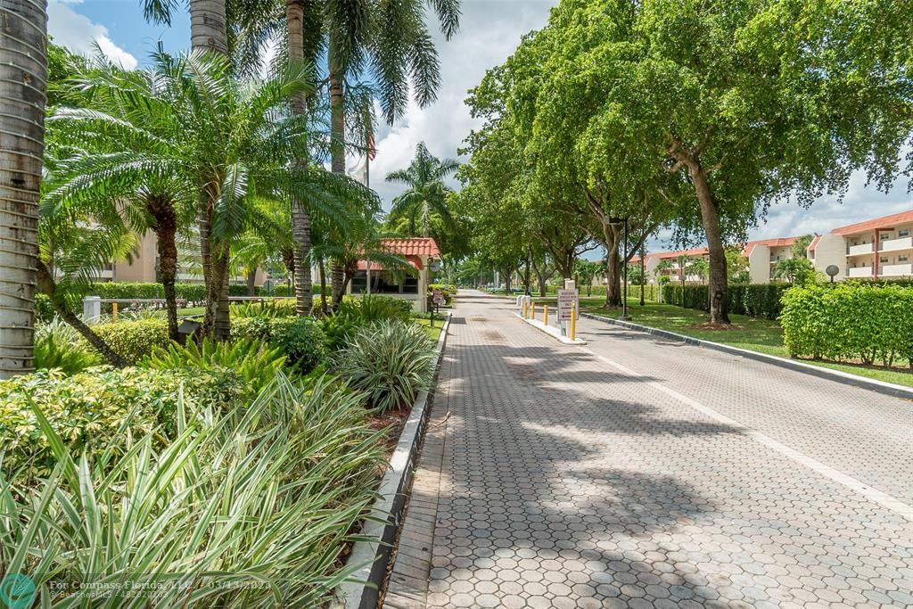 8990 South Hollybrook Boulevard, Unit 301 Pembroke Pines, FL 33025 - Photo 50 of 52 a pathway of a yard
