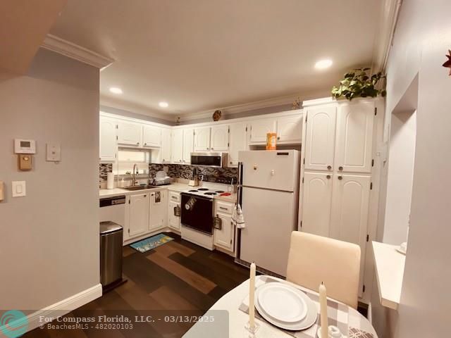 8990 South Hollybrook Boulevard, Unit 301 Pembroke Pines, FL 33025 - Photo 5 of 52 a kitchen with a refrigerator a white stove top oven and sink