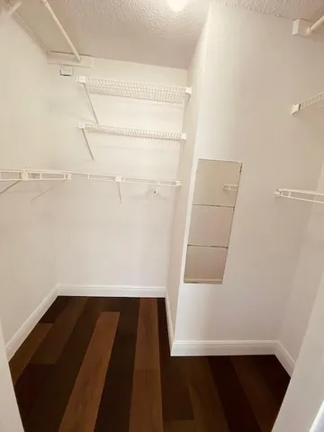 a view of a livingroom with furniture wooden floor and windows