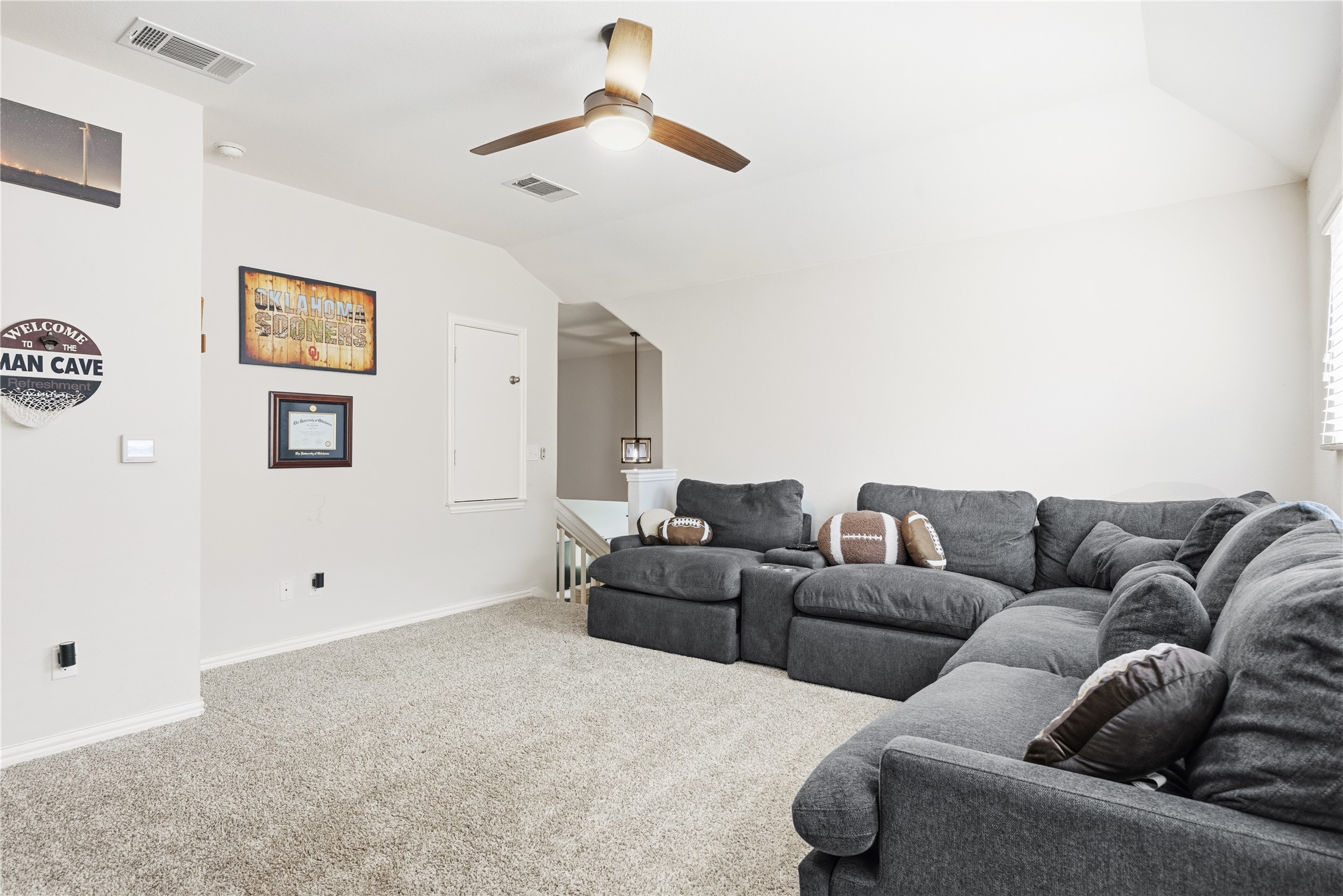 486 Pond View Pass Buda, TX 78610 - Photo 21 of 39 Carpeted bonus room featuring a sloped ceiling with a ceiling fan, white baseboards, and a window with horizontal blinds