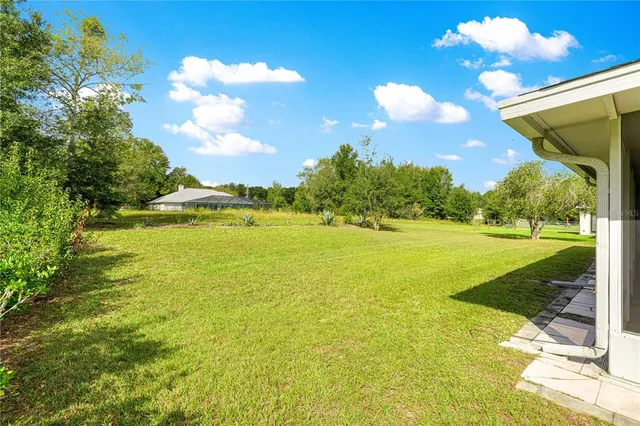 a view of a room with a ceiling fan and a window