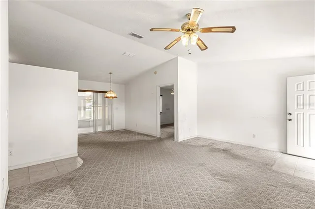 a view of a kitchen with refrigerator and window