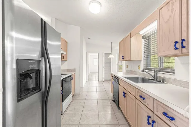 a kitchen with stainless steel appliances granite countertop a refrigerator and a sink