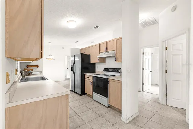 an empty room with a ceiling fan and a bathroom