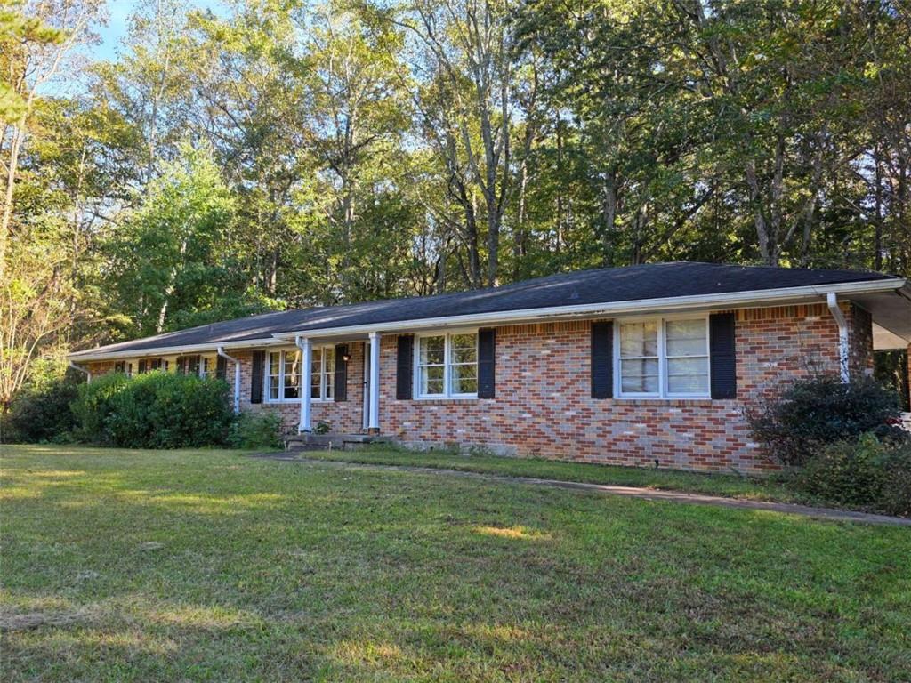 a front view of house with yard and green space