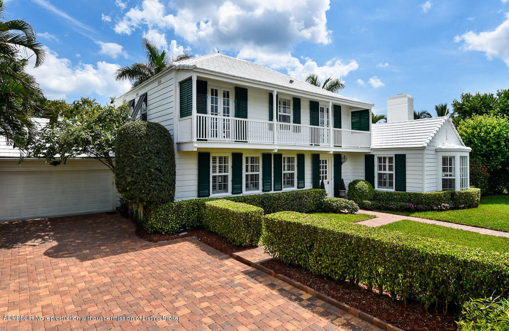 223 Orange Grove Road Palm Beach, FL 33480 - Photo 2 of 12 a front view of a house with garden