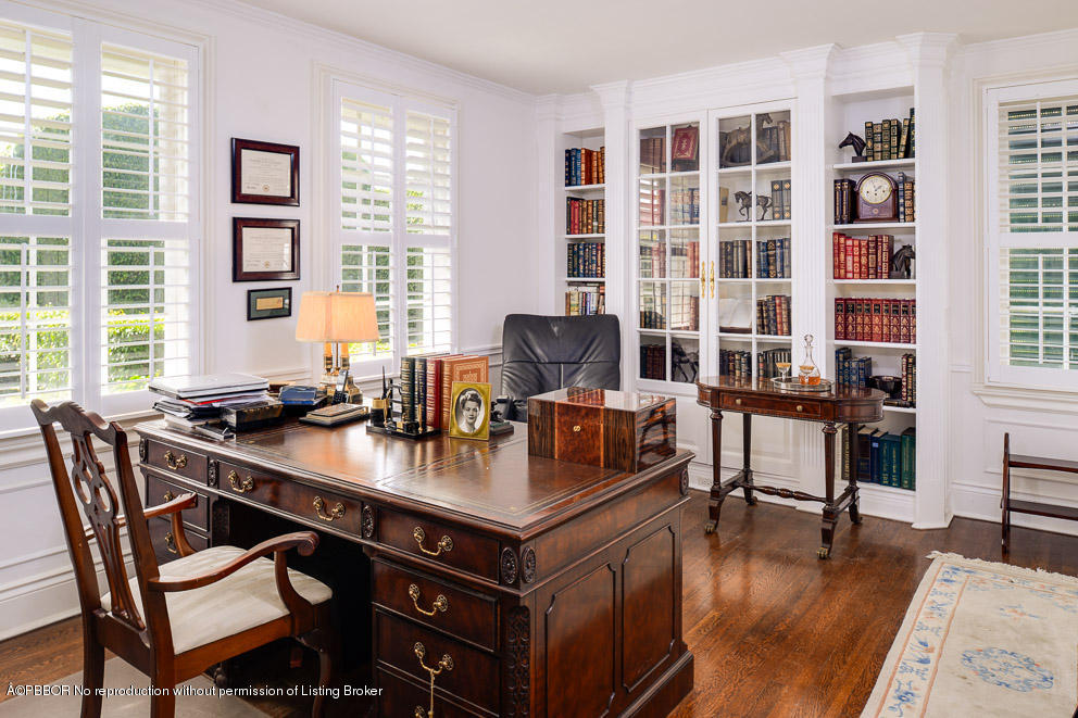 223 Orange Grove Road Palm Beach, FL 33480 - Photo 8 of 12 a view of a workspace with furniture and a bookshelf