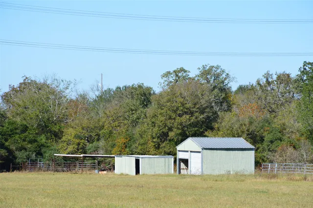 a front view of a house with a yard and mountain view in back