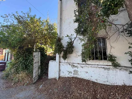 a backyard of a house with table and chairs