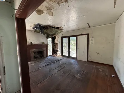 a view of an empty room with a fireplace