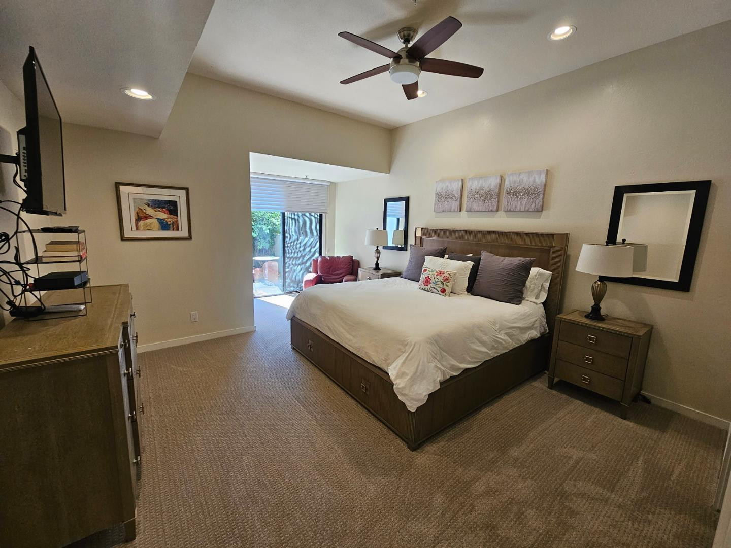 7700 East Gainey Ranch Road, Unit 153 Scottsdale, AZ 85258 - Photo 16 of 24 a spacious bedroom with a bed and a flat screen tv