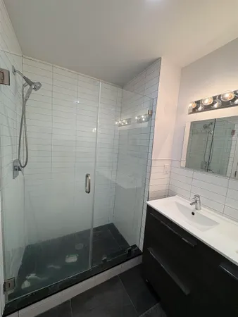 a bathroom with a shower and a sink