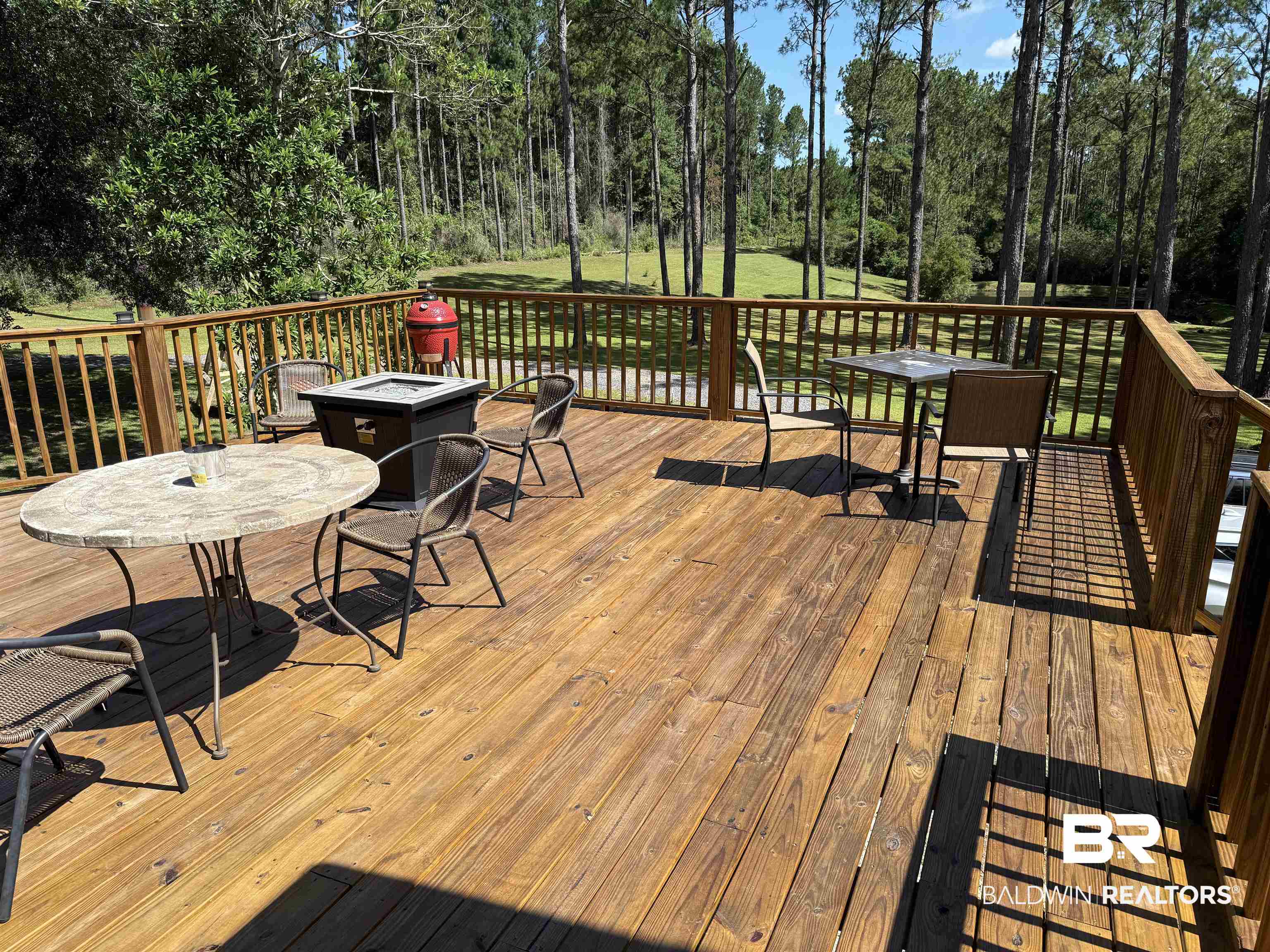 14601 Trawick Road Stapleton, AL 36578 - Photo 24 of 37 Deck with an outdoor fire pit, view of wooded area, and outdoor dining space