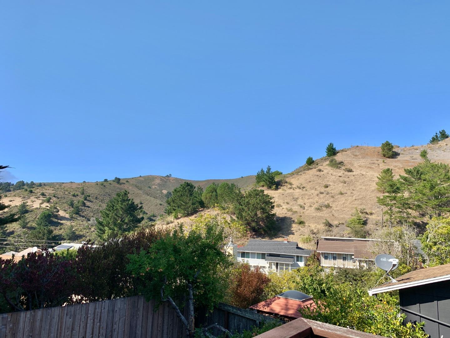 1291 Park Pacifica Avenue Pacifica, CA 94044 - Photo 15 of 18 a view of a house with a mountain in the background