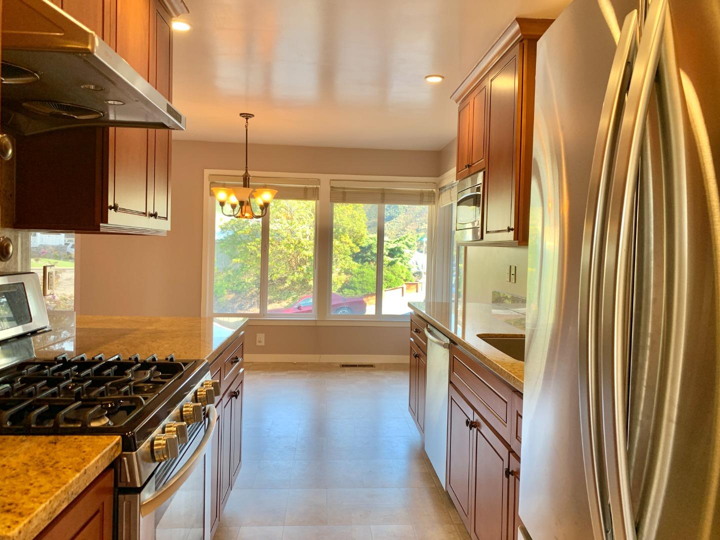 1291 Park Pacifica Avenue Pacifica, CA 94044 - Photo 7 of 18 a kitchen with window a sink and stainless steel appliances