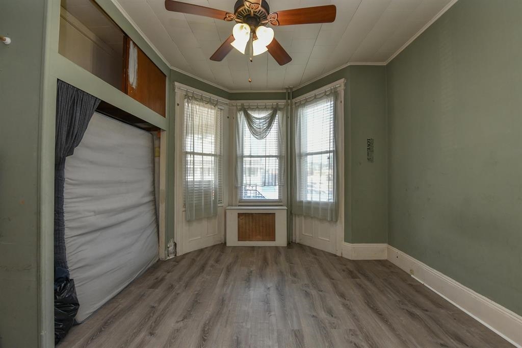 426 Hancock Place Fairview, NJ 07022 - Photo 12 of 14 a view of an empty room with wooden floor and a window