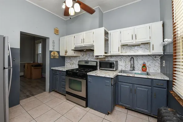 a kitchen with stainless steel appliances granite countertop a sink and cabinets