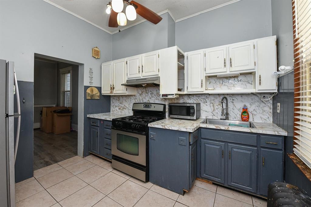 426 Hancock Place Fairview, NJ 07022 - Photo 2 of 14 a kitchen with stainless steel appliances granite countertop a sink and cabinets
