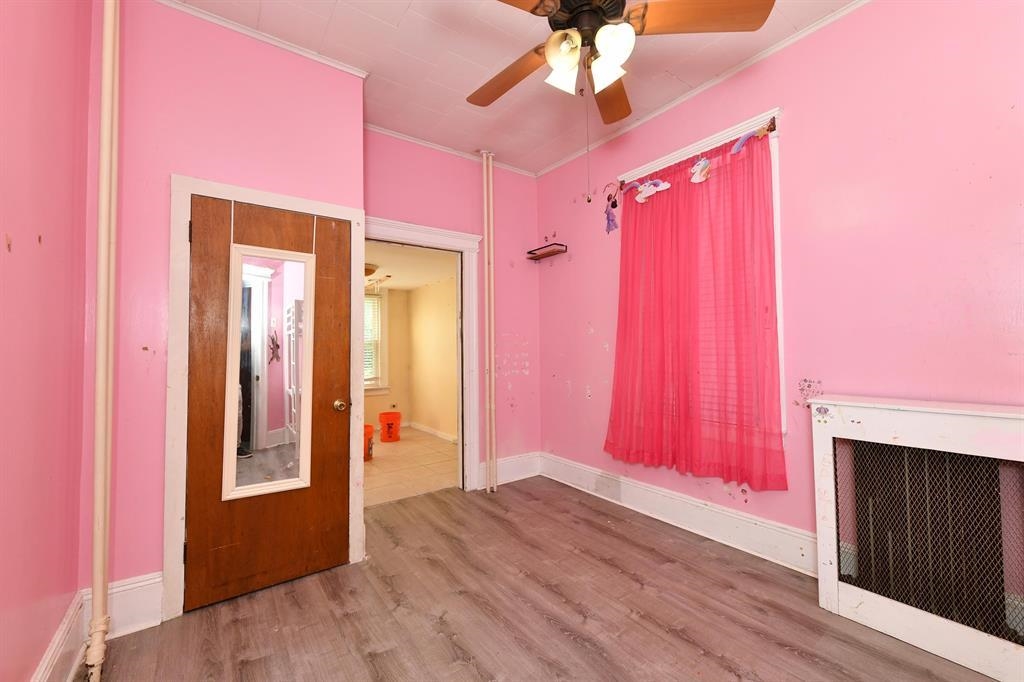 426 Hancock Place Fairview, NJ 07022 - Photo 9 of 14 a view of a livingroom with a chandelier fan and a fireplace