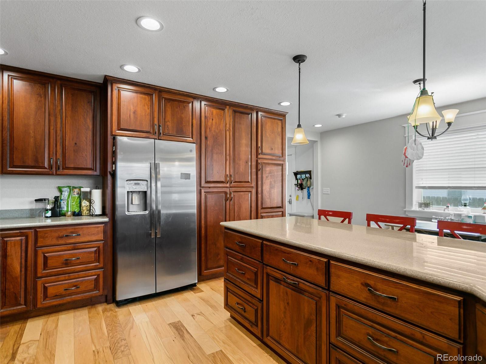 a kitchen with granite countertop stainless steel appliances and wooden cabinets