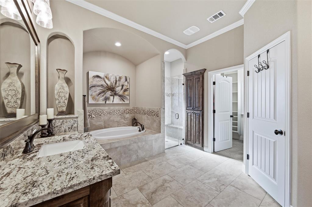 121 Bluff Ridge Court Paradise, TX 76073 - Photo 15 of 33 Full bathroom with a bath, a stall shower, vanity, ornamental molding, and a spacious closet