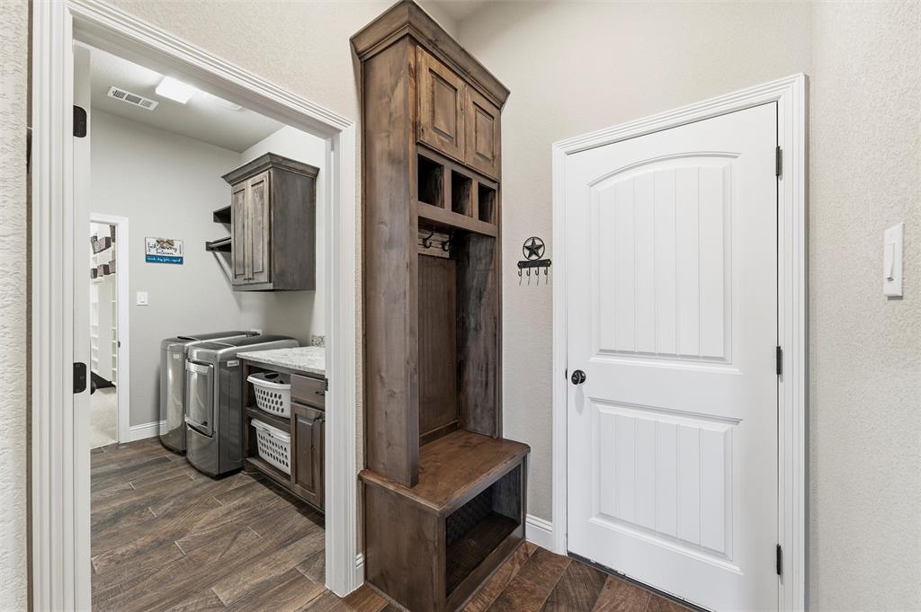 121 Bluff Ridge Court Paradise, TX 76073 - Photo 19 of 33 Mudroom with wood tiled floors, independent washer and dryer, and a textured wall
