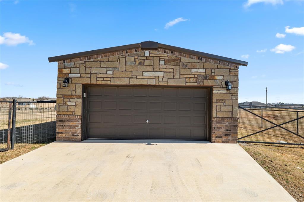 121 Bluff Ridge Court Paradise, TX 76073 - Photo 27 of 33 Garage with concrete driveway