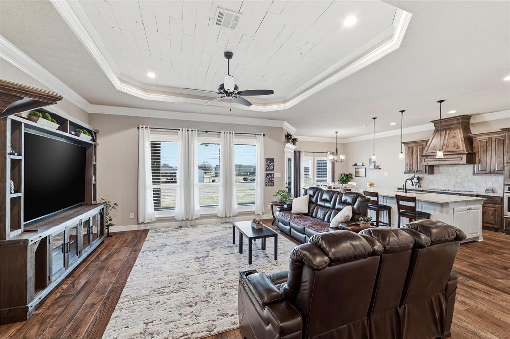 121 Bluff Ridge Court Paradise, TX 76073 - Photo 4 of 33 Living area with a chandelier, ceiling fan, dark wood-style floors, a tray ceiling, and recessed lighting