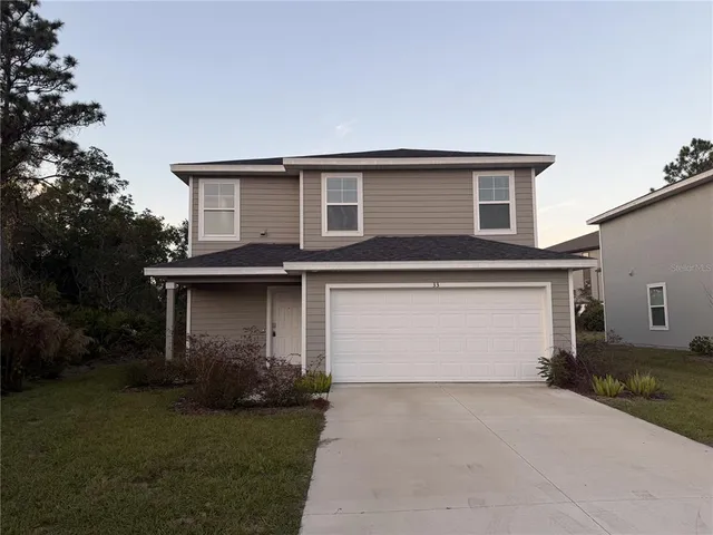 a front view of house with backyard and green space