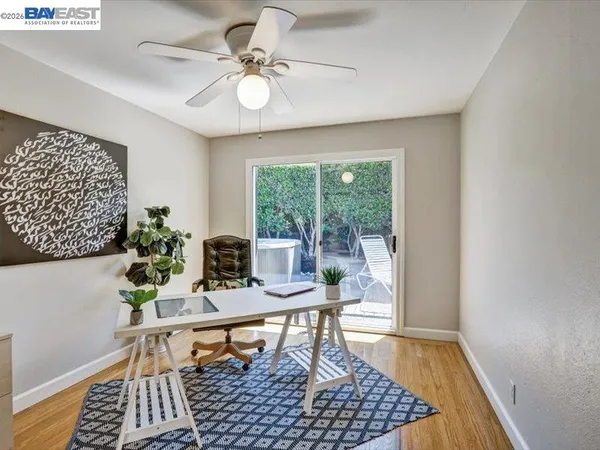 a dining room with wooden floor and a rug