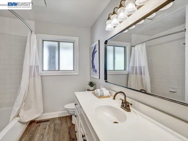 a bathroom with a sink a toilet and a mirror