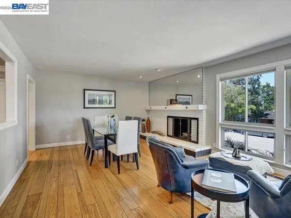 a living room with furniture a fireplace and a table