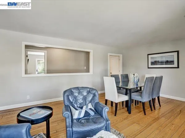 a dining room with furniture and wooden floor