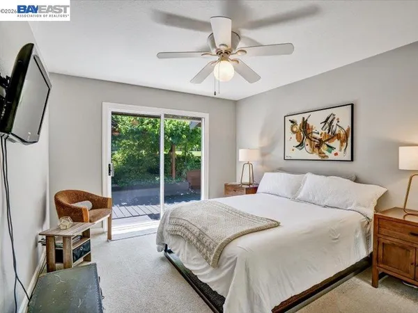a bedroom with a bed a couch and a window