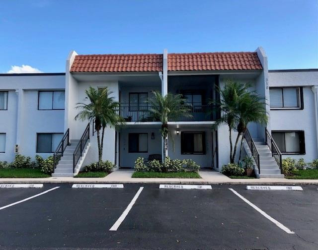 310 Racquet Club Road, Unit 203 Weston, FL 33326 - Photo 1 of 14 front view of a house with a street