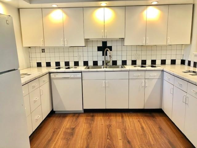 310 Racquet Club Road, Unit 203 Weston, FL 33326 - Photo 3 of 14 a kitchen with a sink window and white cabinets