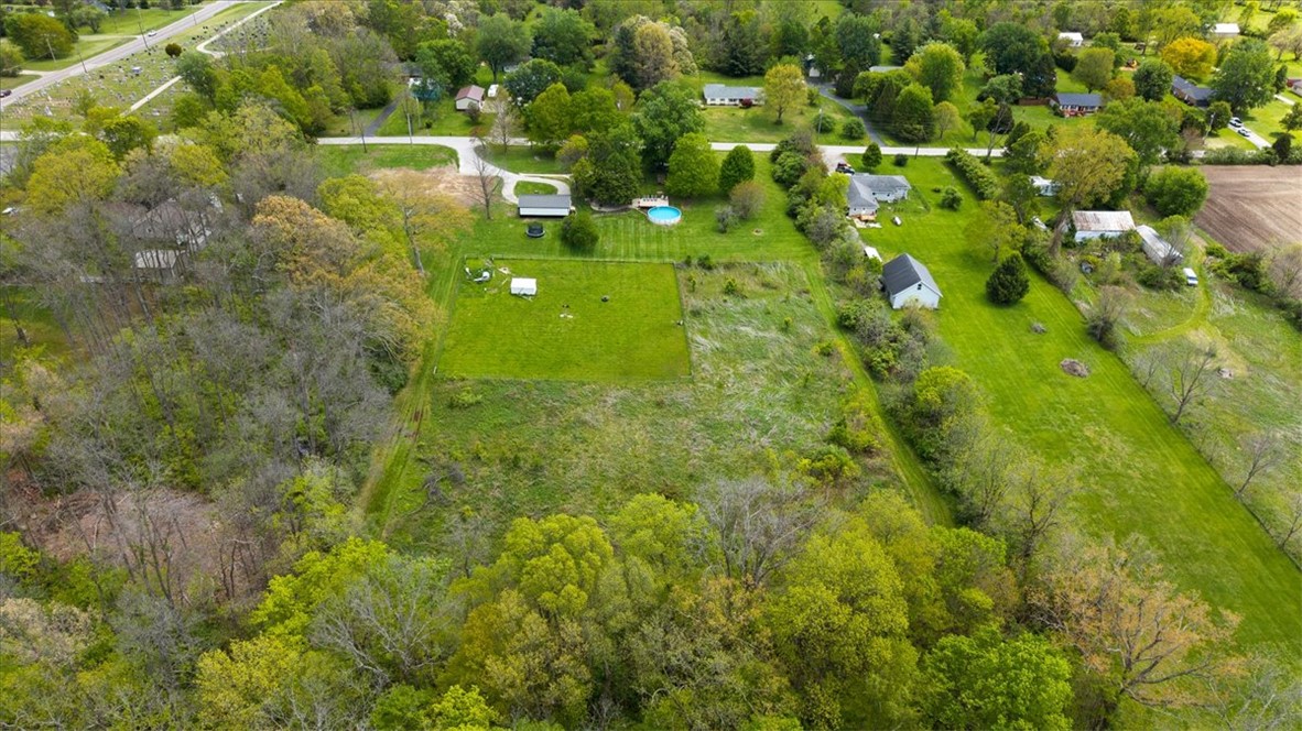 5120 Wheelock Road Troy, OH 45373 - Photo 62 of 67 Expansive green spaces and mature trees surround this property, offering a serene rural setting.