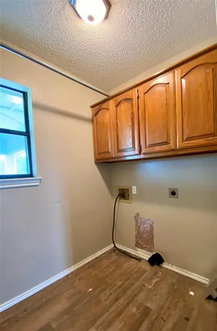 a room with a wooden floor and a window